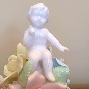 VINTAGE CHERUB atop a mound of flowers